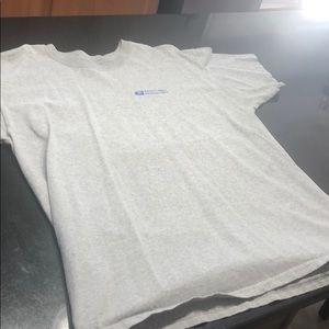 Gray T-shirt says safety first Nashua. PMpc xl